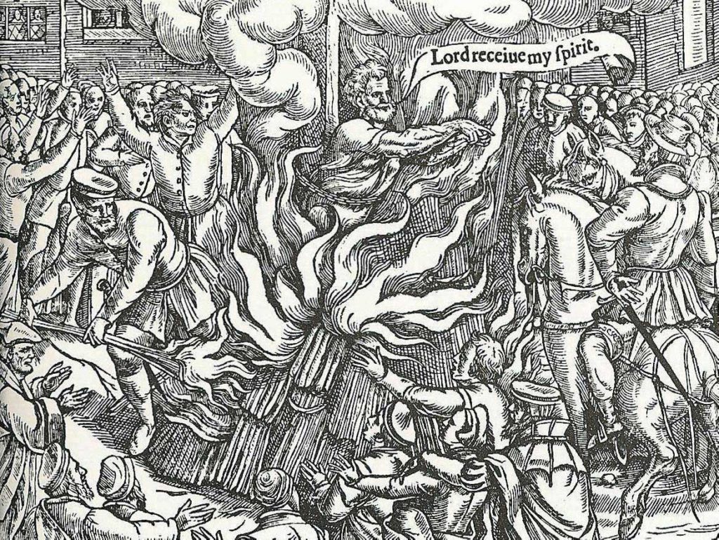 John Rogers siendo quemado en la hoguera, grabado en madera del Libro de los mártires de John Foxe.